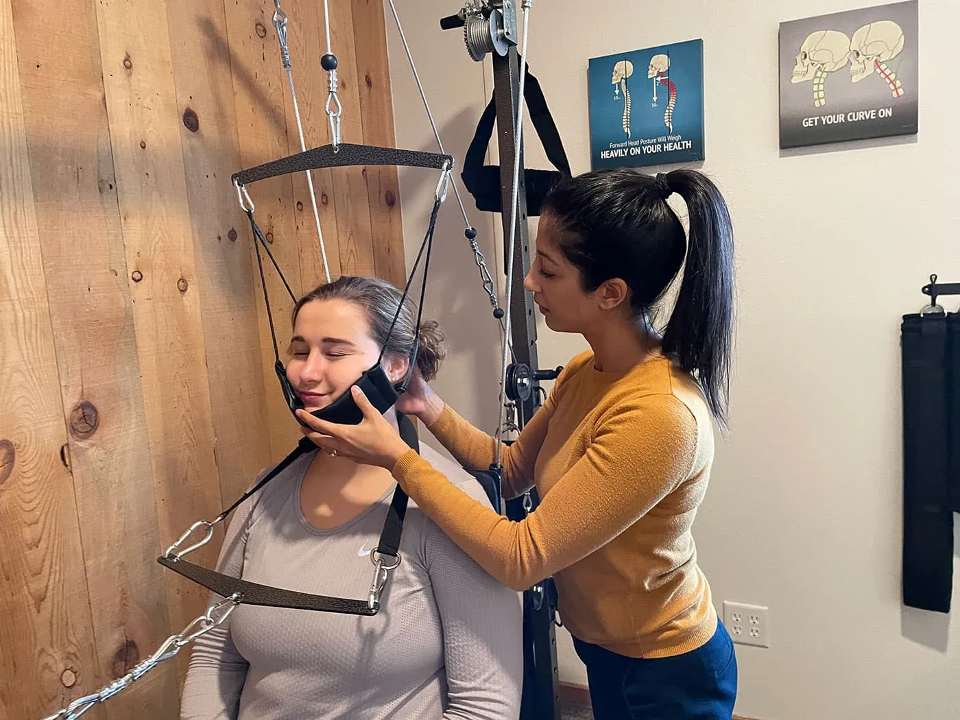 Young woman receiving whiplash treatment at Elevation Spine Center